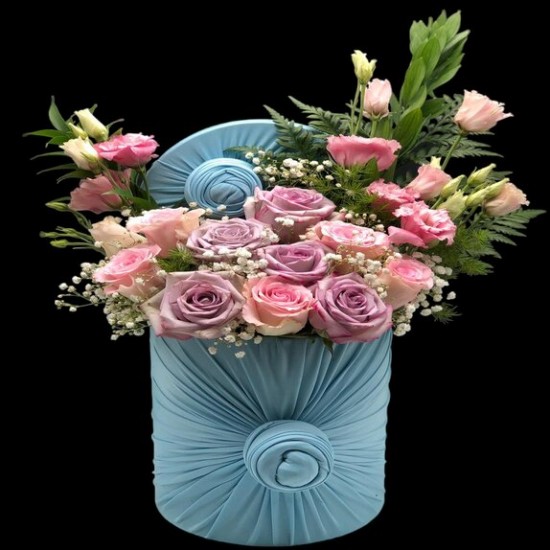 Sarah - A fabric vase containing 16 roses and 4 baby roses with feathers